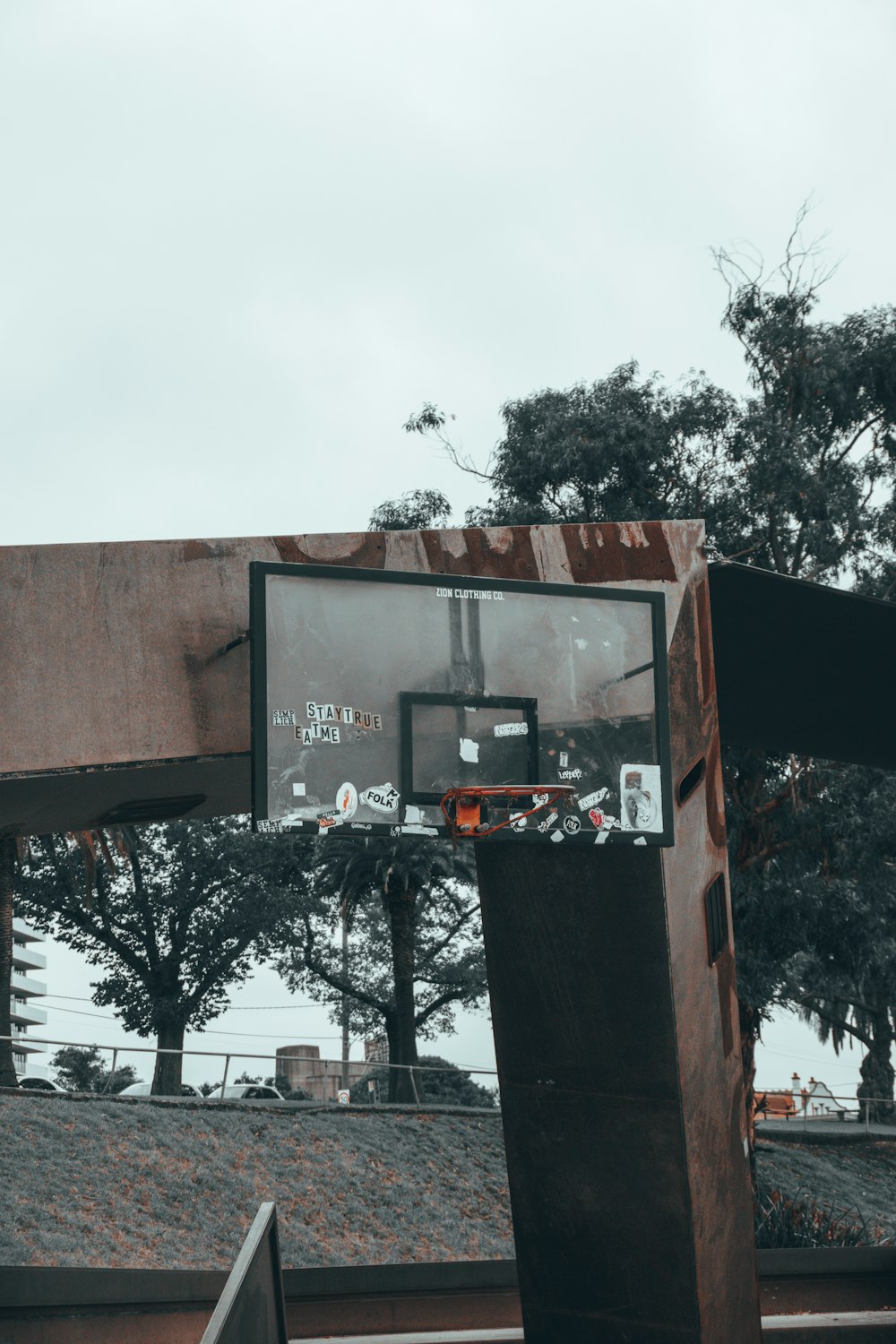 a basketball hoop in front of some trees