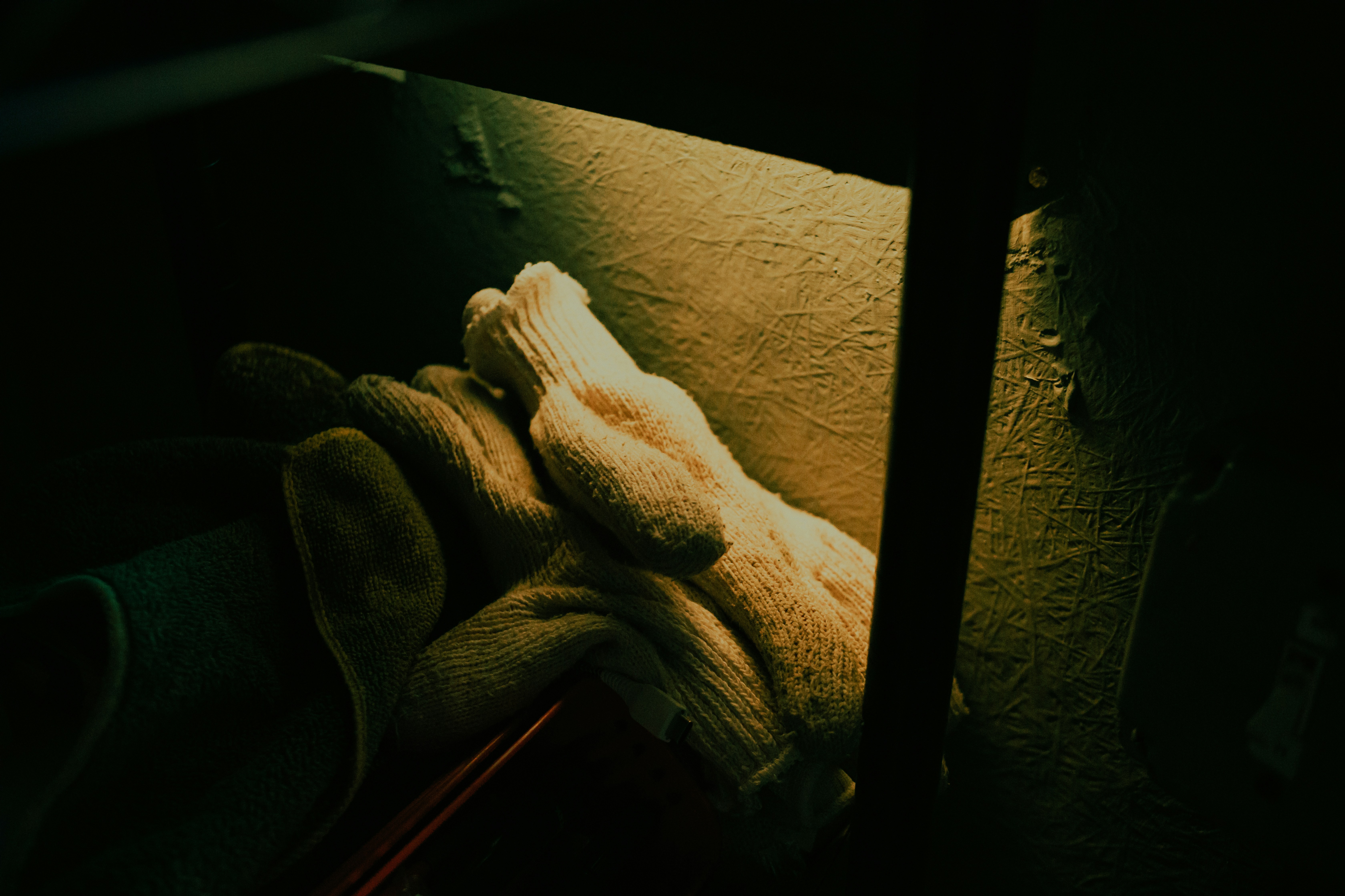 Heavy duty work gloves on dark workshop surface, industrial photography