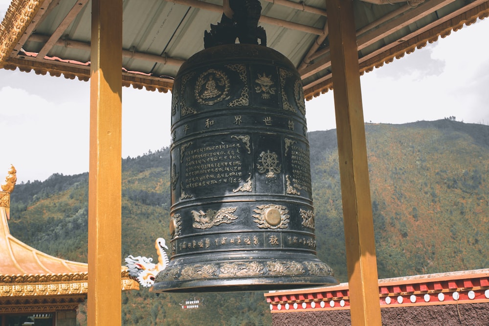 a bell with a statue on top of it