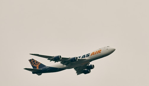 a large jetliner flying through a cloudy sky