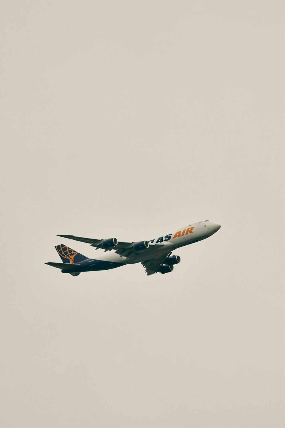a large jetliner flying through a cloudy sky