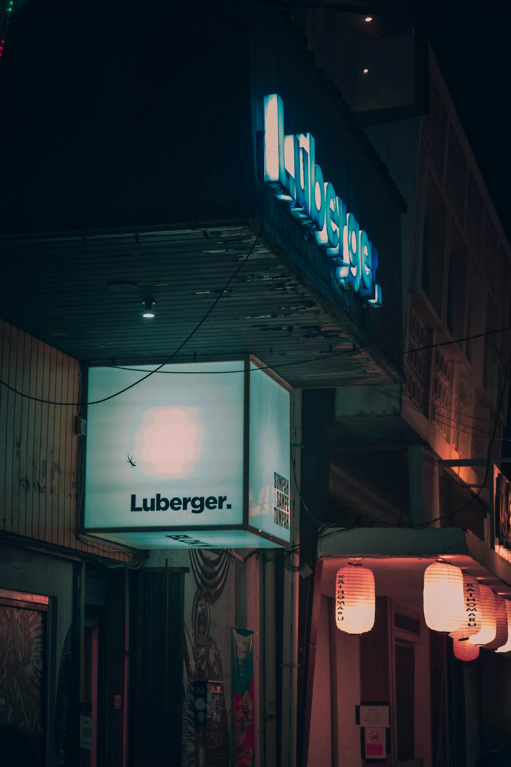 a building with a lit up sign above it