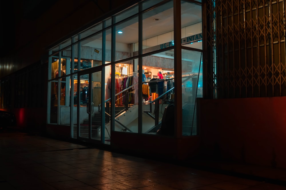 a store front at night with the lights on