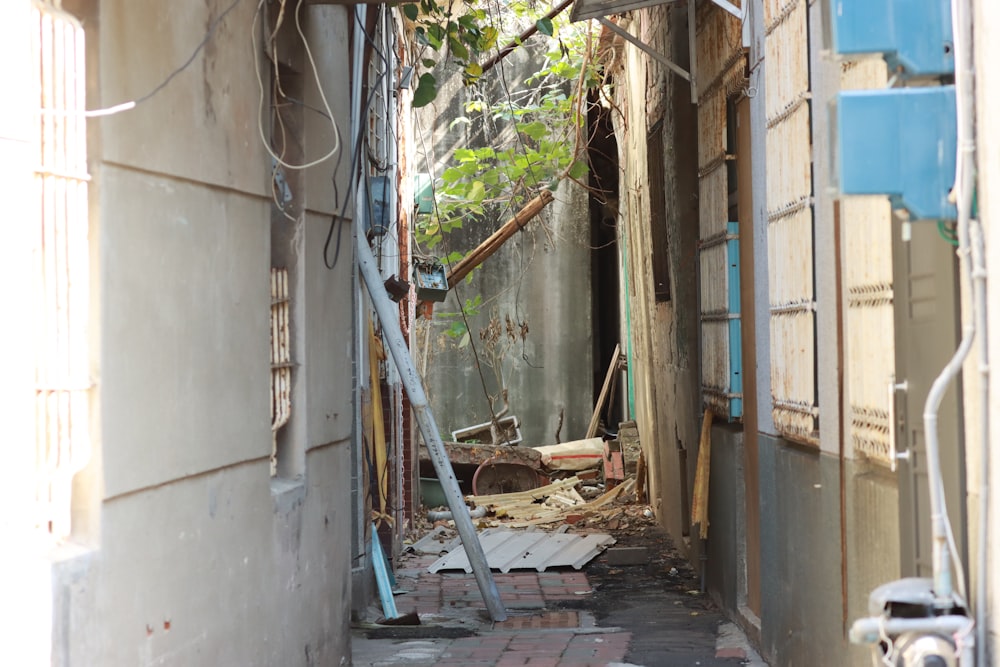 a narrow alley way with a broken down chair