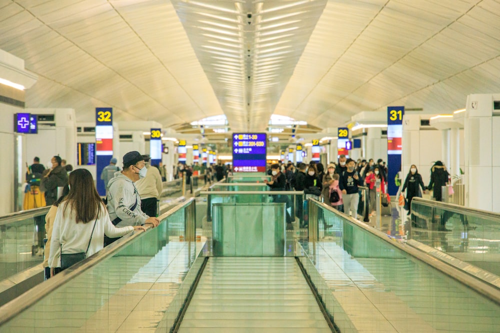 a group of people standing around an airport