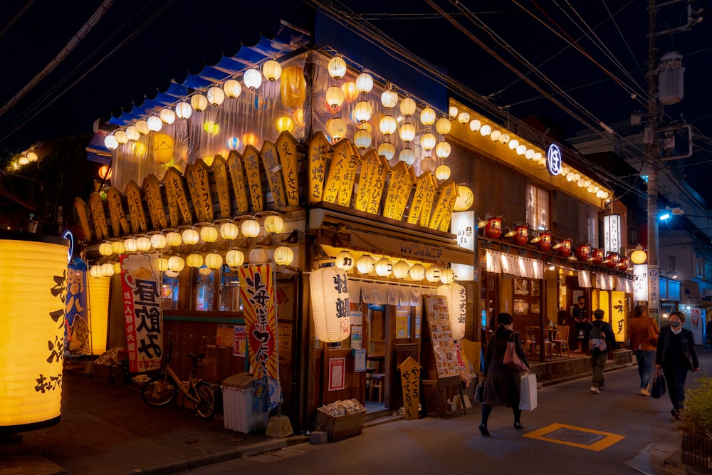 a building with lanterns hanging from it's roof