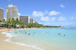 a beach with people swimming in the water
