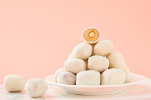 Stacked milk cakes with a soft texture, dusted lightly with cardamom powder.