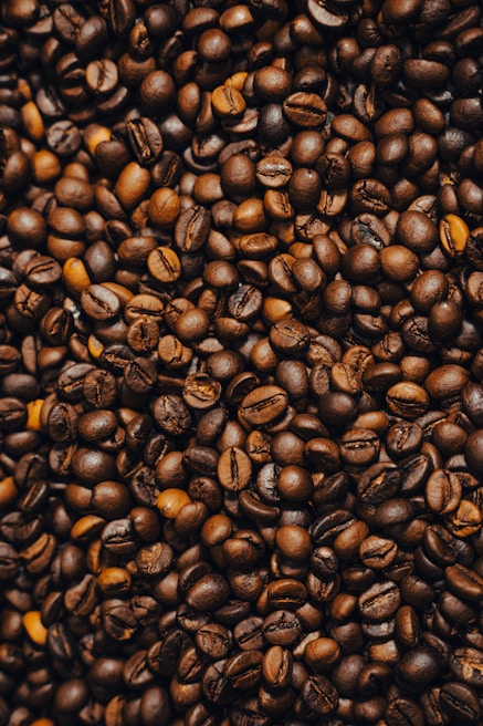 Close-up of coffee beans spilling from a burlap sack, highlighting their deep brown color.