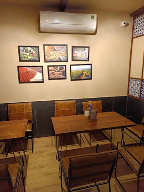 Cozy AC room with warm lighting and neat furnishings at Nivasara.