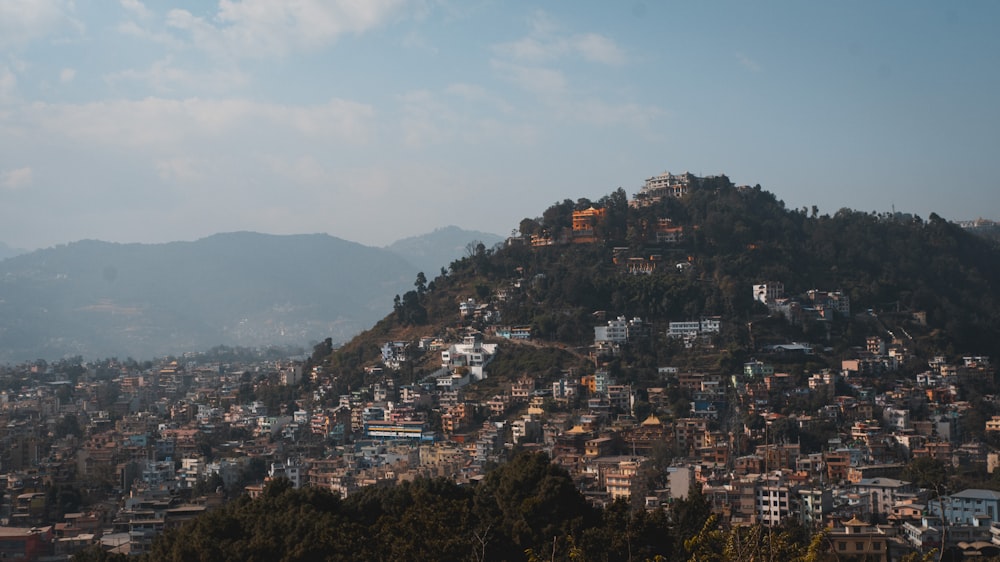 a city on a hill surrounded by trees