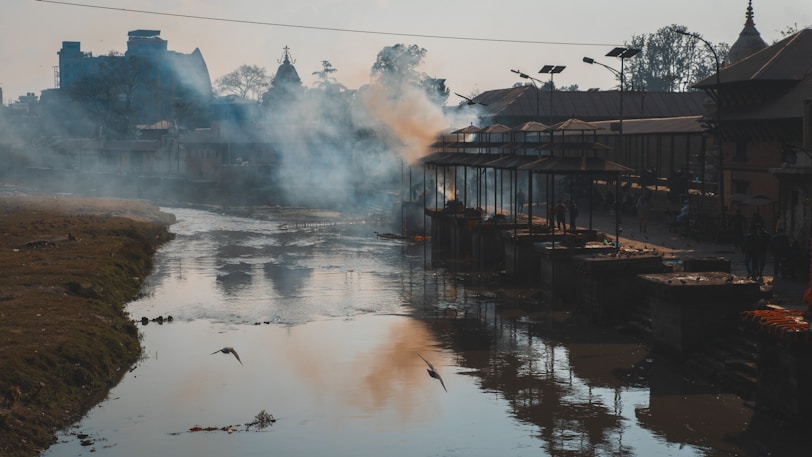 a body of water with steam rising from it
