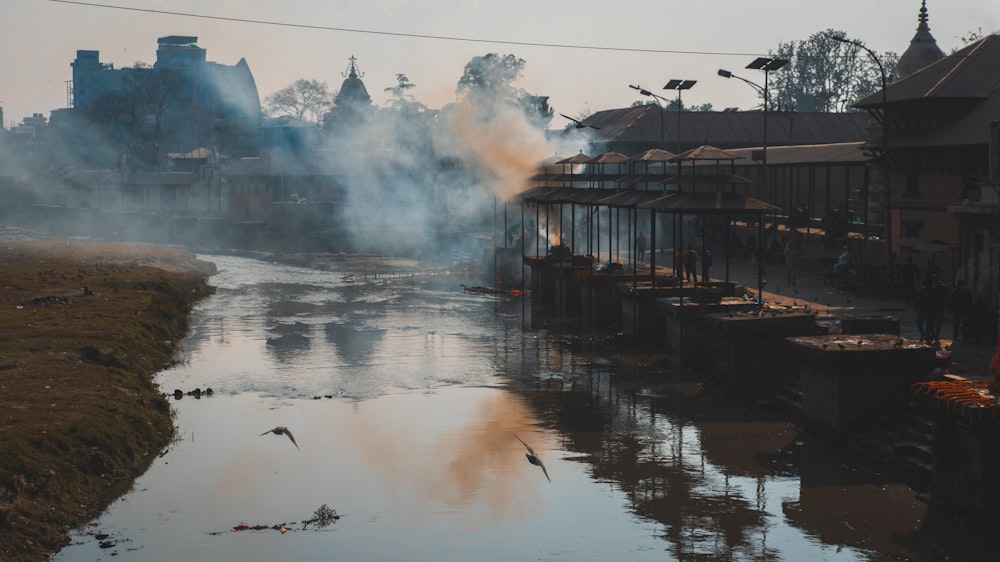 a body of water with steam rising from it