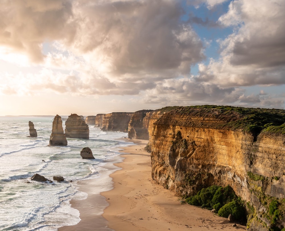 a view of a beach with a cliff in the background