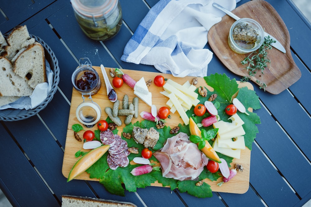 a wooden cutting board topped with lots of food