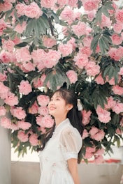 A beautiful girl in a dreamy pink setting, showcasing her allure.