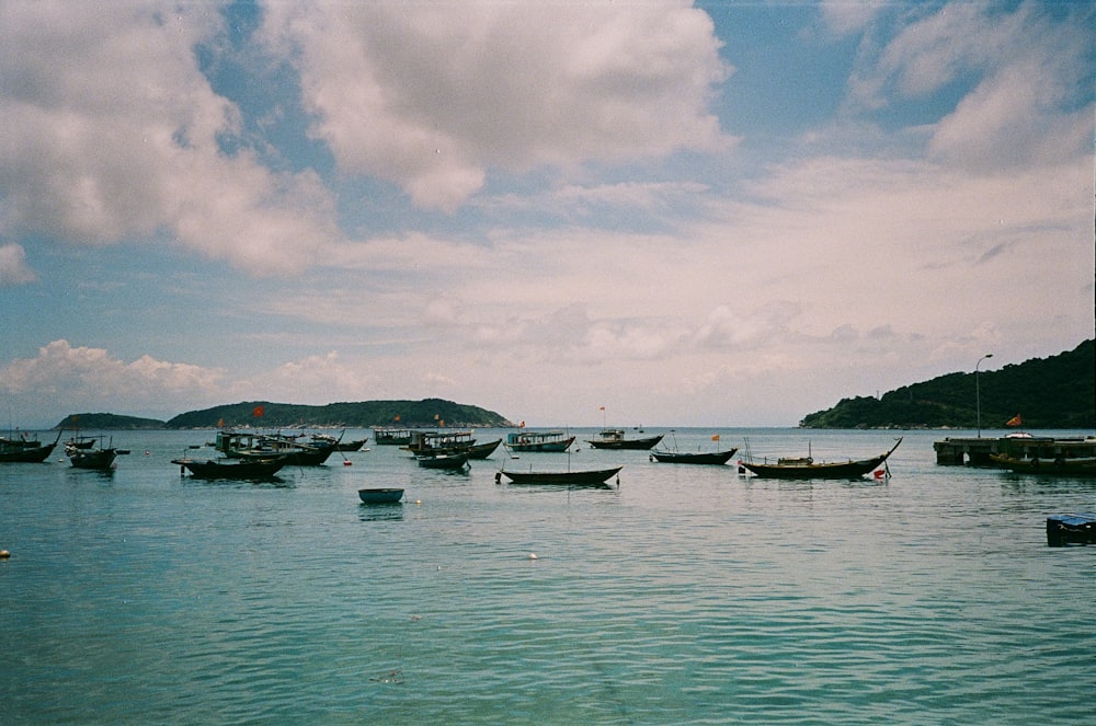 a group of boats floating on top of a body of water