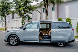 a silver minivan parked on the side of the road