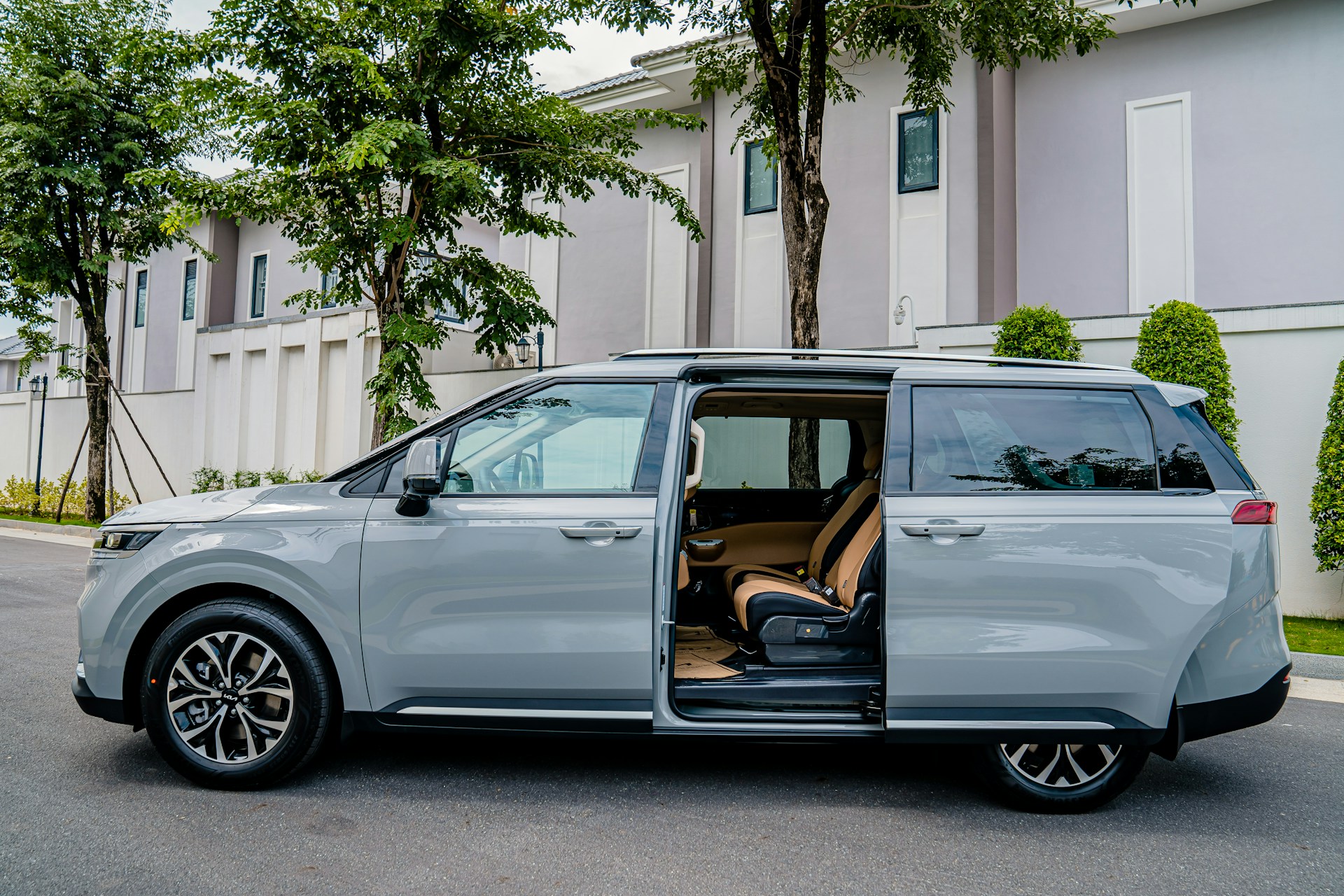 a silver minivan parked on the side of the road