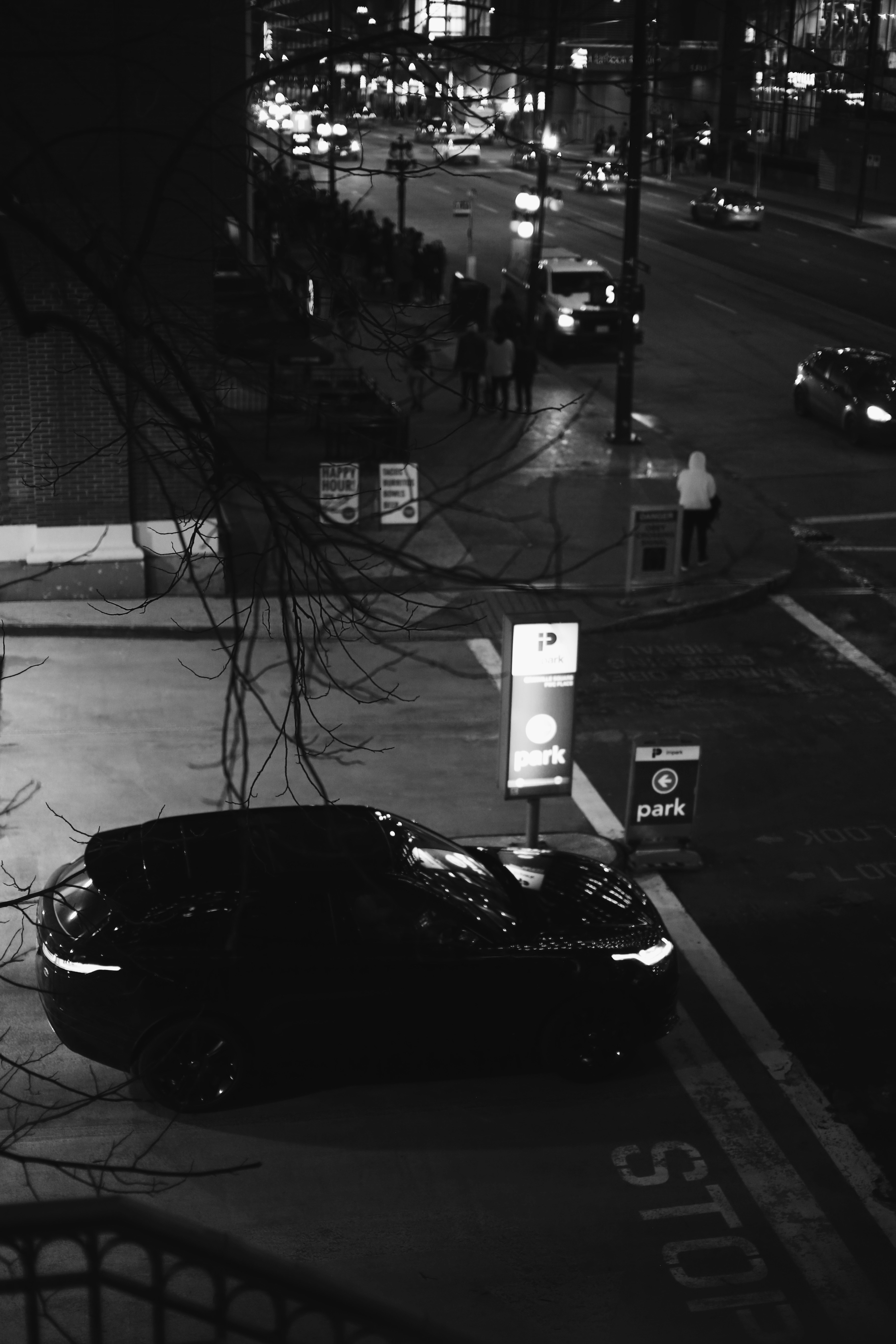 Black luxury SUV parked at airport terminal at night, dramatic dark lighting, professional driver visible