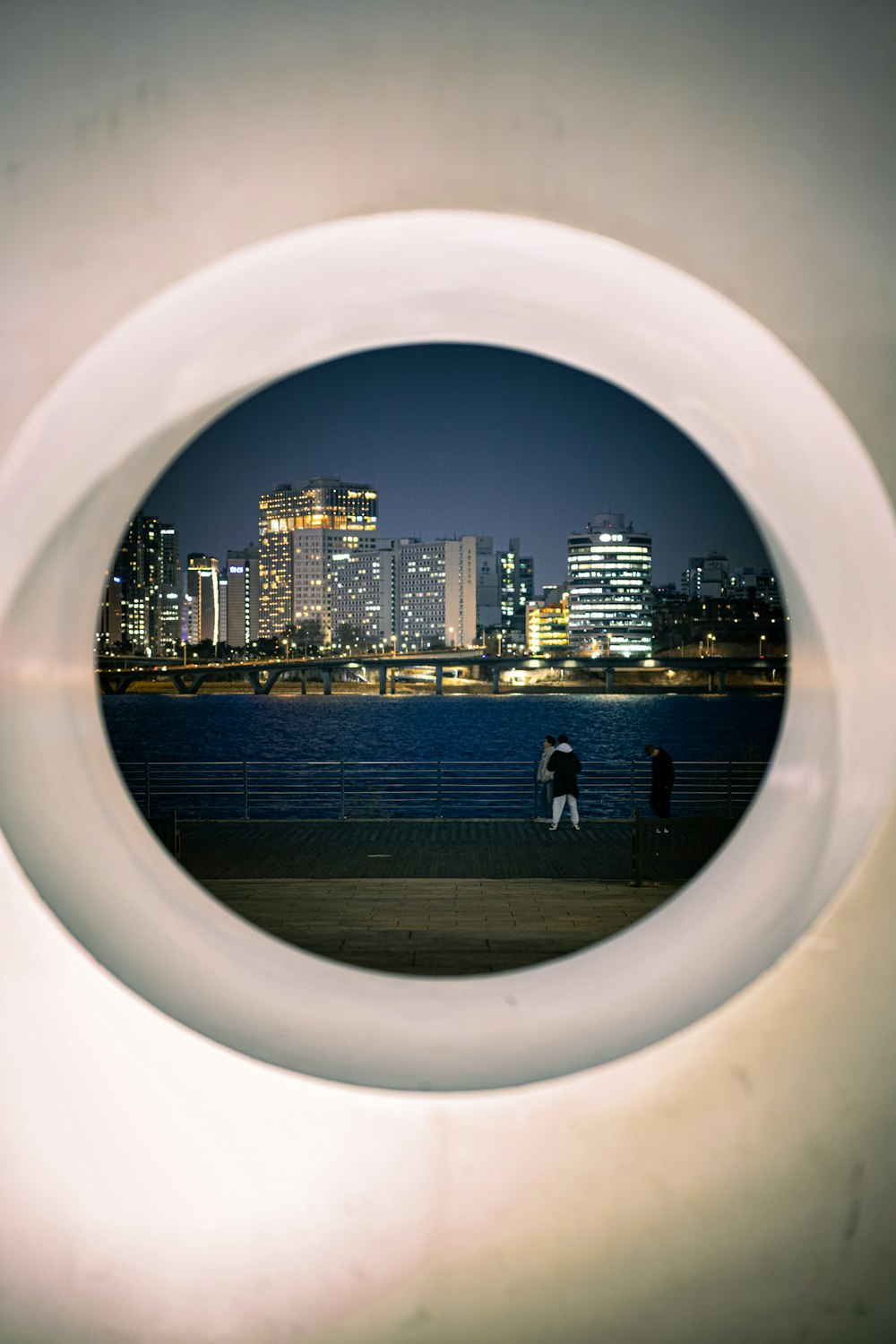 a view of a city from a circular object