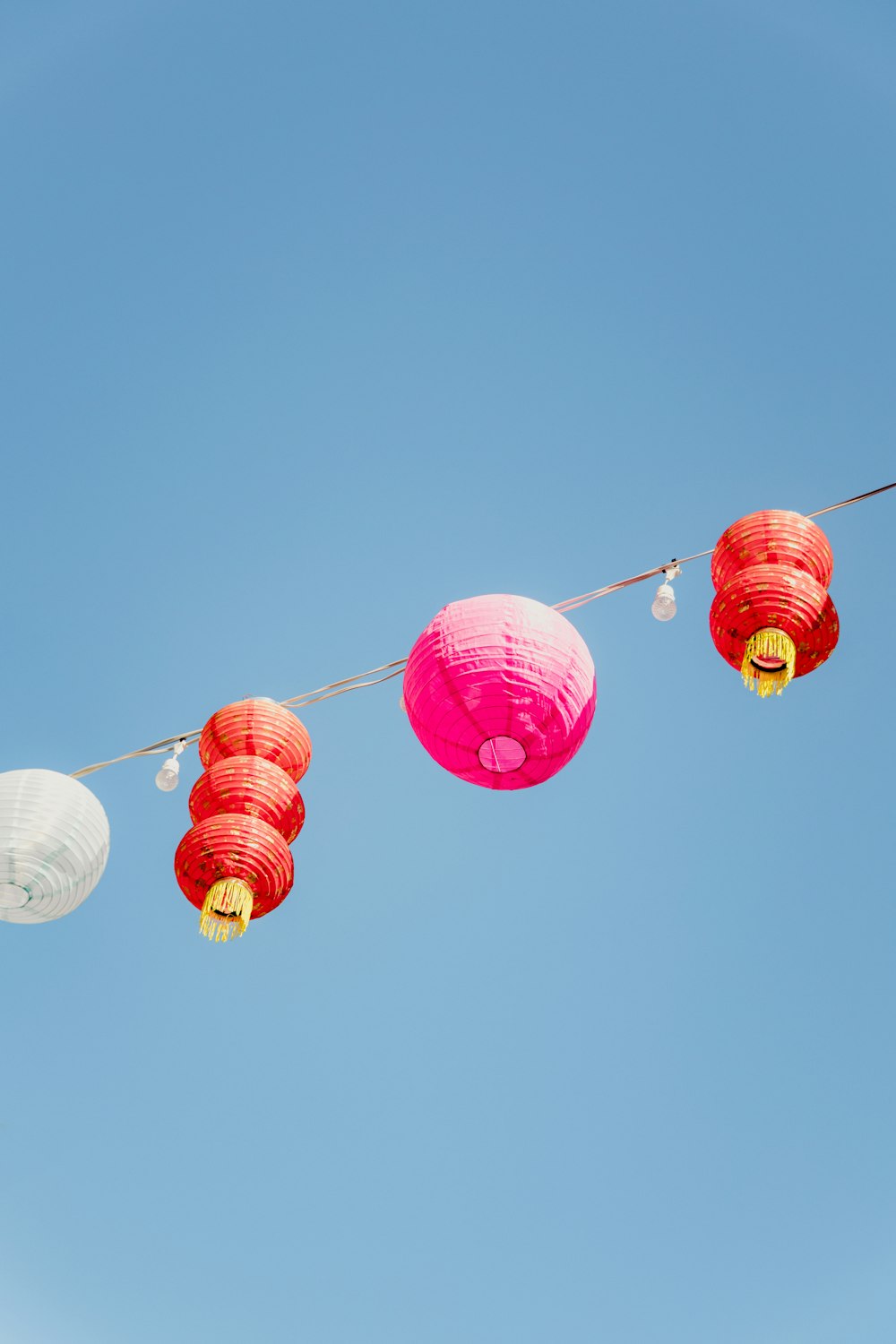 a string of paper lanterns hanging from a line
