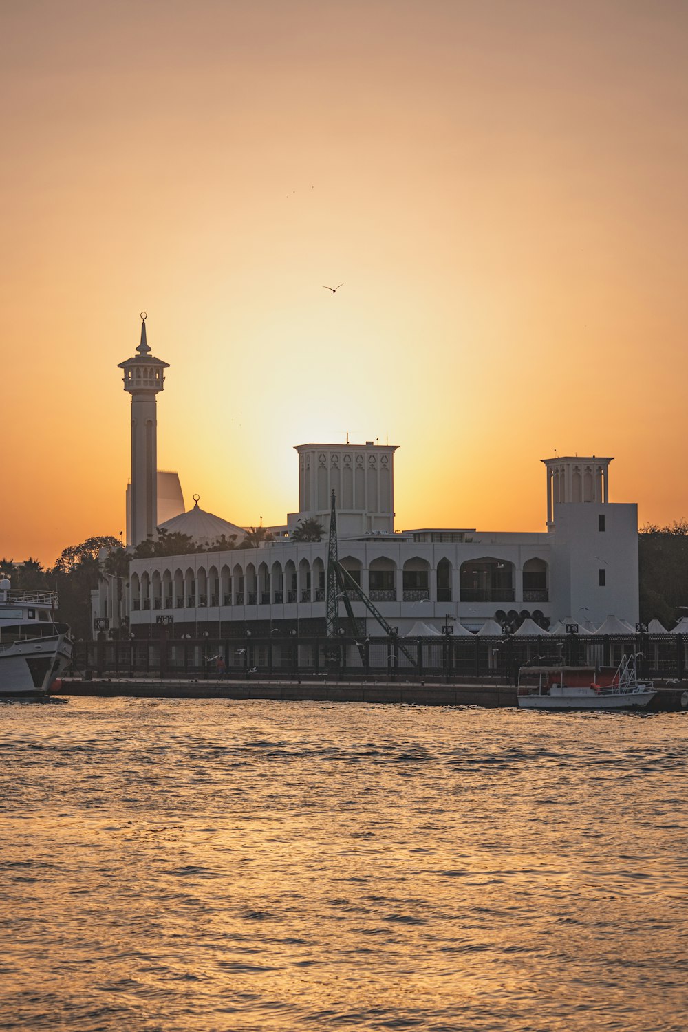 a large body of water with a building in the background