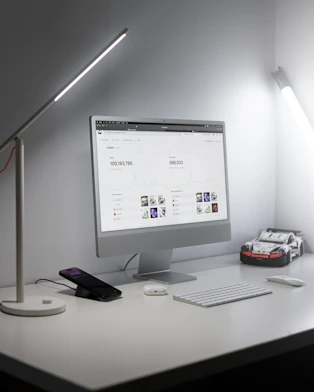 A sleek, minimal workspace with soft lighting and a modern computer screen displaying clean AI data visualizations.