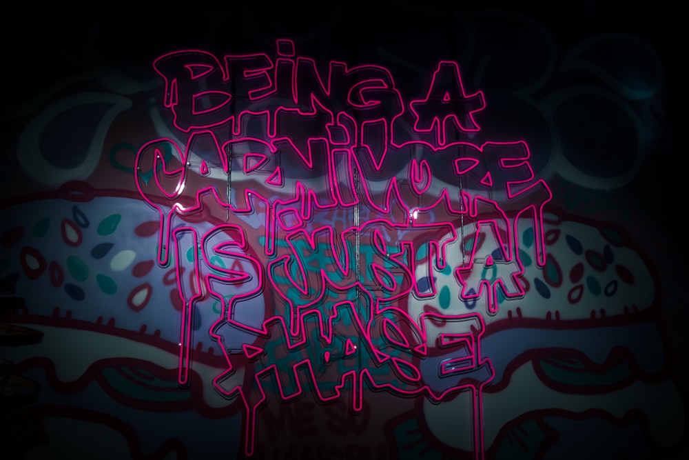 a neon sign that says being a carnivor is not a crime