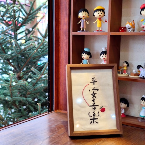 Decorative small ornaments arranged on a wooden shelf.