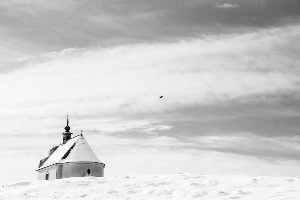 a black and white photo of a church in the snow