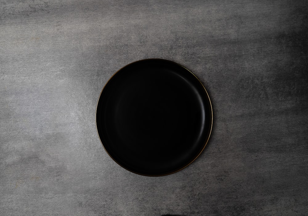 a black plate sitting on top of a table