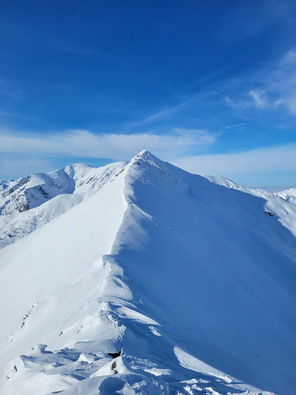 a person skiing down a snow covered mountain