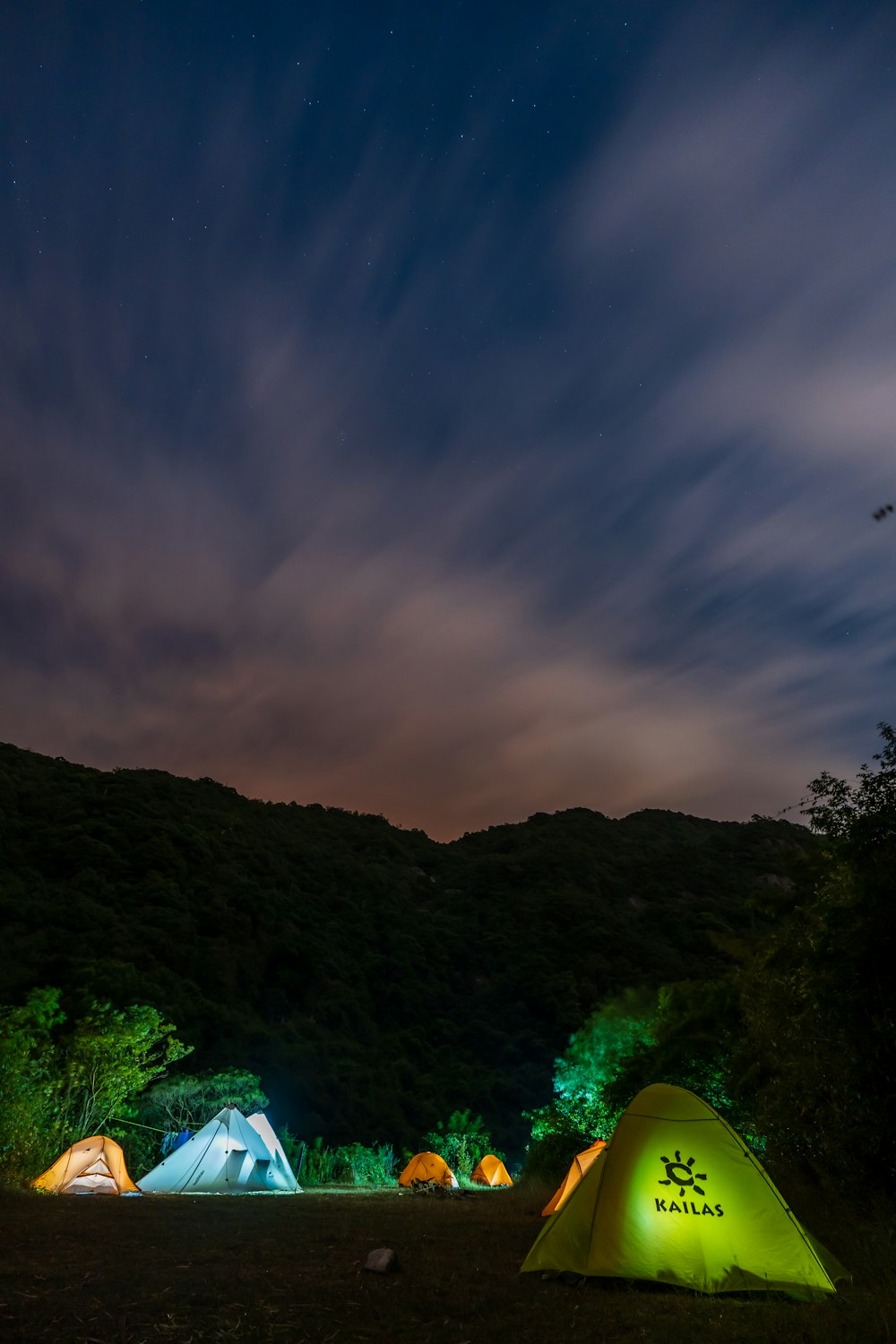 a group of tents lit up at night