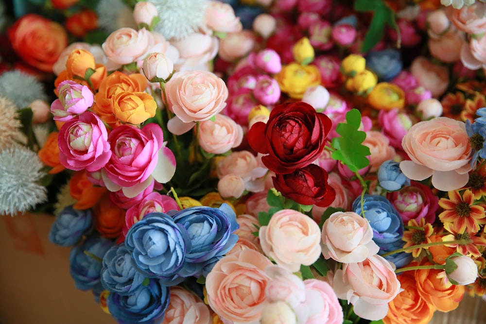 a bunch of colorful flowers sitting on top of a table