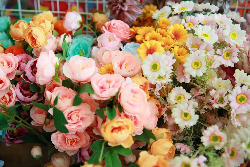 a basket filled with lots of different colored flowers