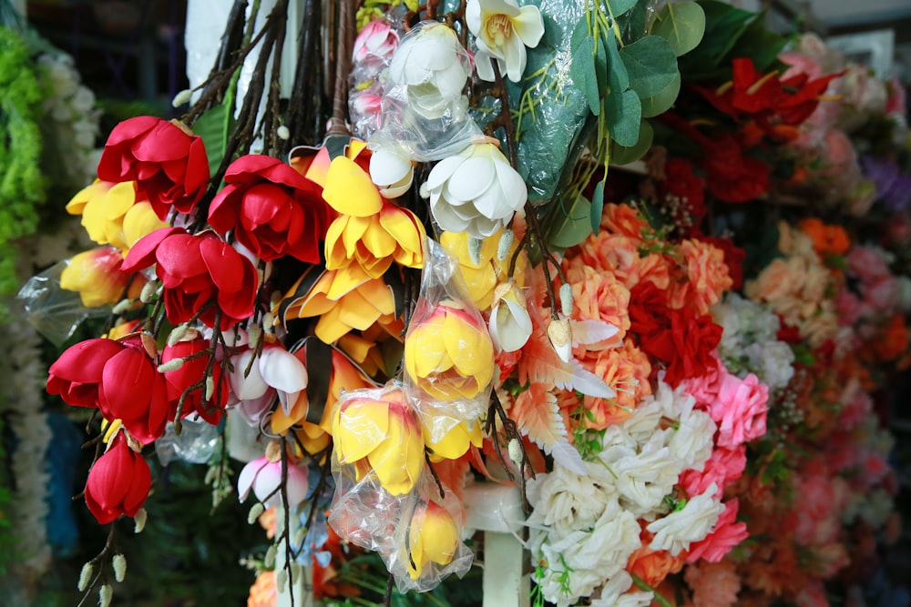 a bunch of flowers that are hanging on a wall