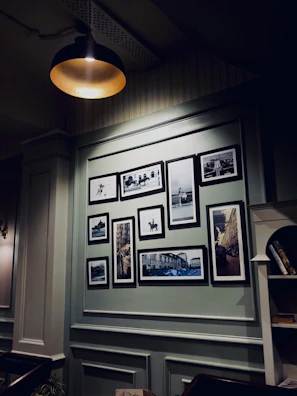 Historic family photographs displayed in a warm, wood-paneled room.