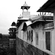 a black and white photo of a building with a clock tower
