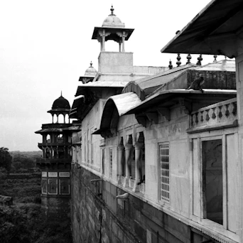 a black and white photo of a building with a clock tower