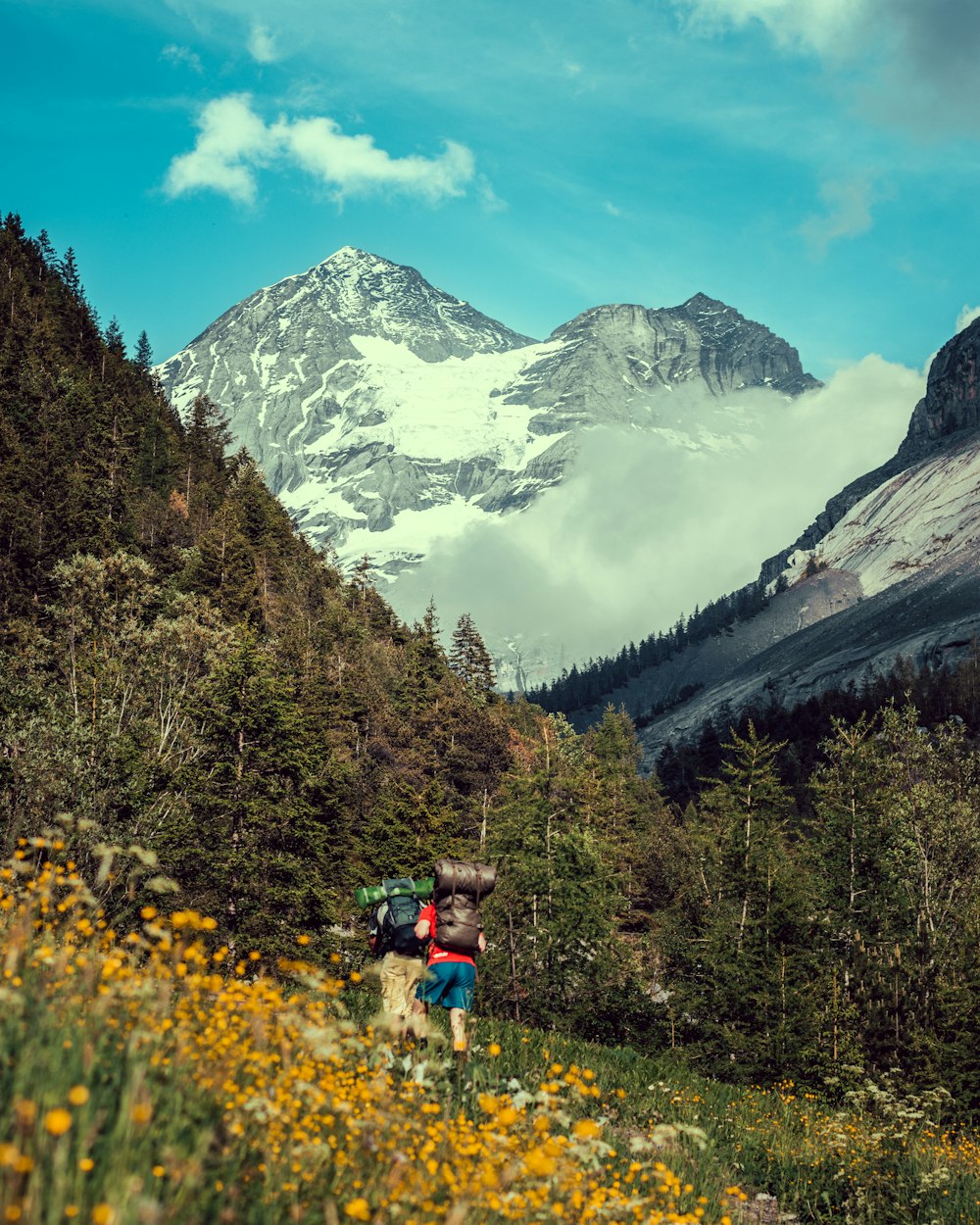 a man with a backpack hiking up a mountain