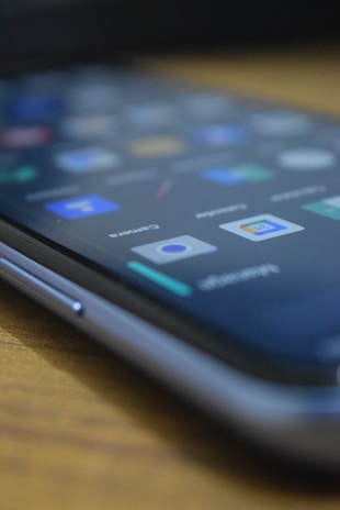 A close-up of a smartphone with a Whilix review displayed on the screen.