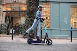 A close-up of a person riding an electric bike on a city street.
