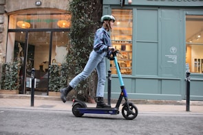 A close-up of a person riding an electric bike on a city street.