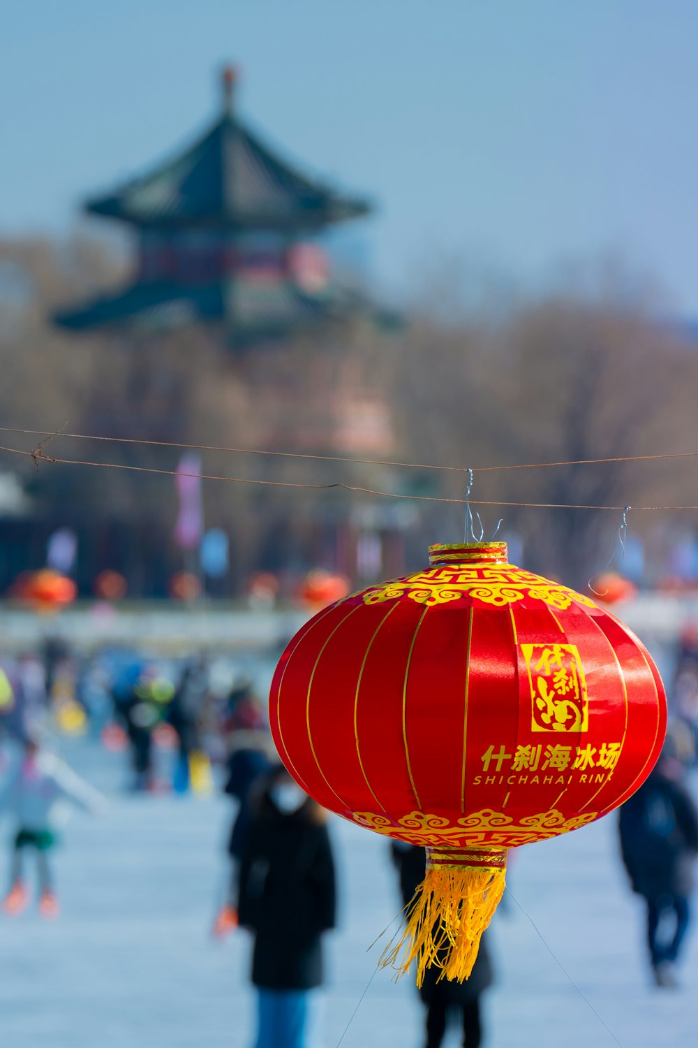 a group of people standing around a red lantern