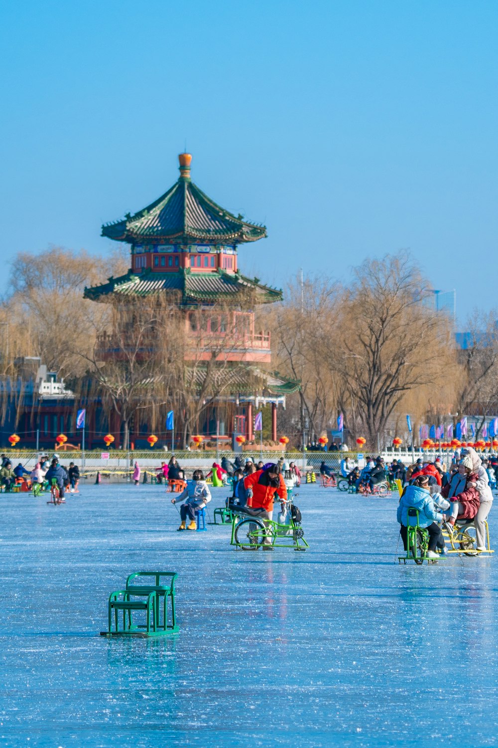 a group of people sitting on top of a frozen lake