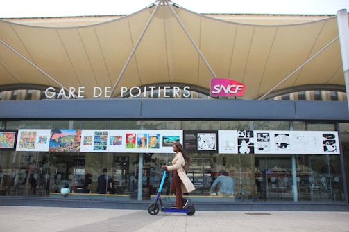 A professional moto taxi waiting outside a Paris train station.