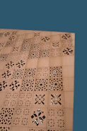 Close-up of laser-cut acrylic sheets with intricate designs