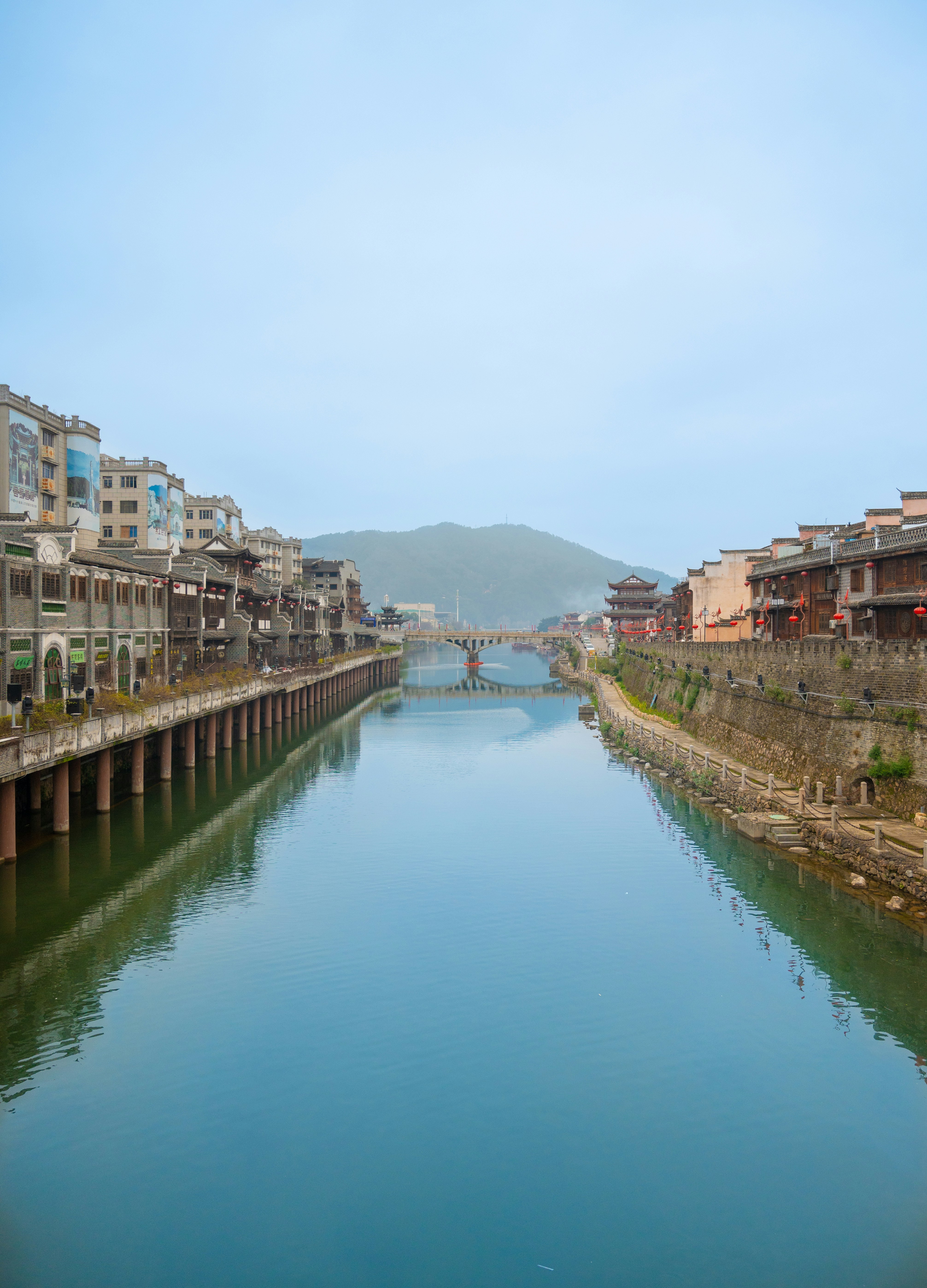 a river running through a city next to tall buildings