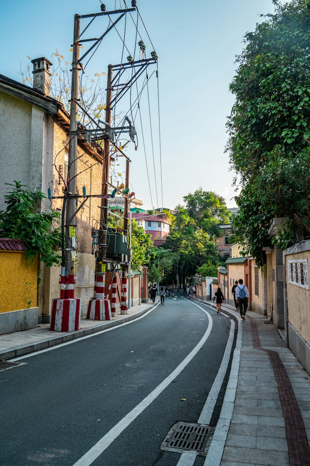 a couple of people walking down a street